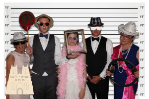 party guests posing for green screen photo of a police lineup