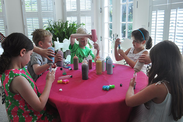party guests sitting at a table making sand art