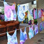 tie-dye tees drying on a clothes line