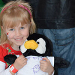 Young girl with her fill-a-friend stuffed animal penguin.