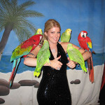 parrot guy - party goer posing with live parrots