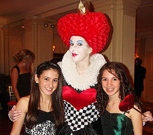 Queen of Hearts Impersonator with party guests