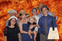 party guests posing for green screen photo in front of a fire