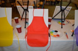Display of paint and canvases for juice box and paint party for kids