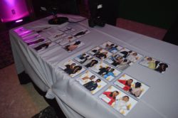 display of photos party guests posed for in front of a green screen