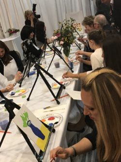 guests painting at a paint night hosted at event