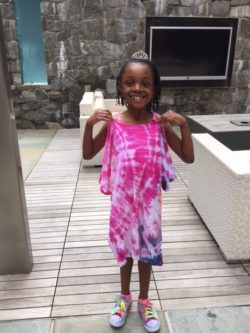 Happy girl showing off her tie-dye tee